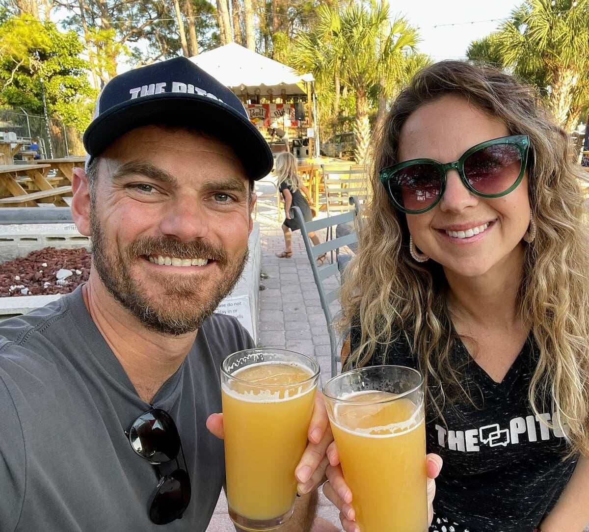 Josh and Lisa Muccio toasting in Pitch merch